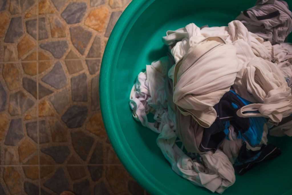 dirty clothes in wash basket