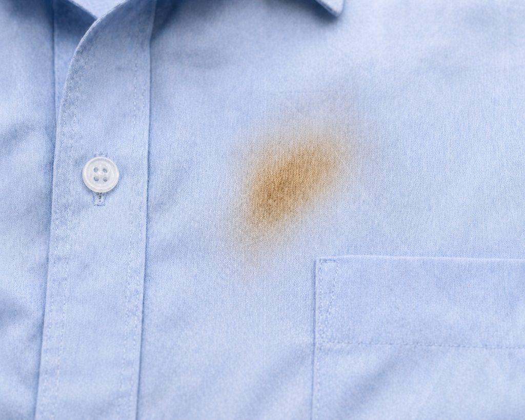 A scorch mark on a light blue shirt from an iron.